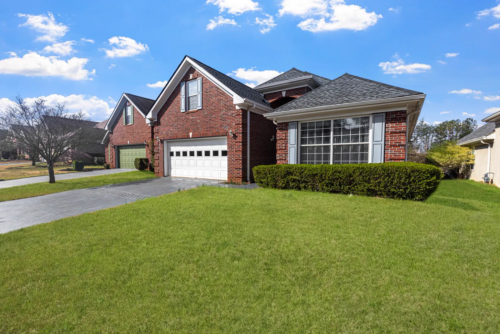Brick suburban home with a gabled roofline and white gutters