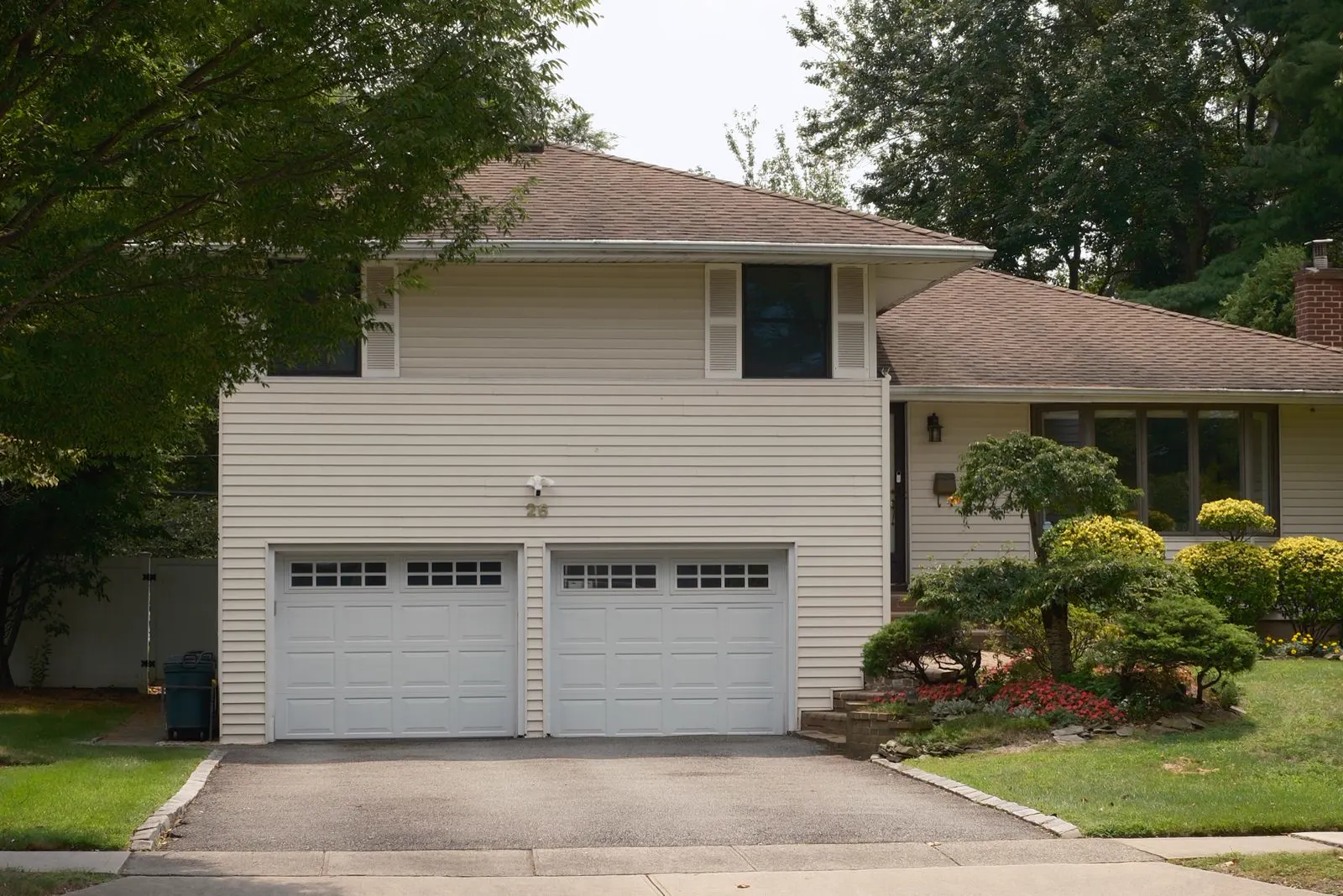 Two-story suburban home with a front porch and attached garage