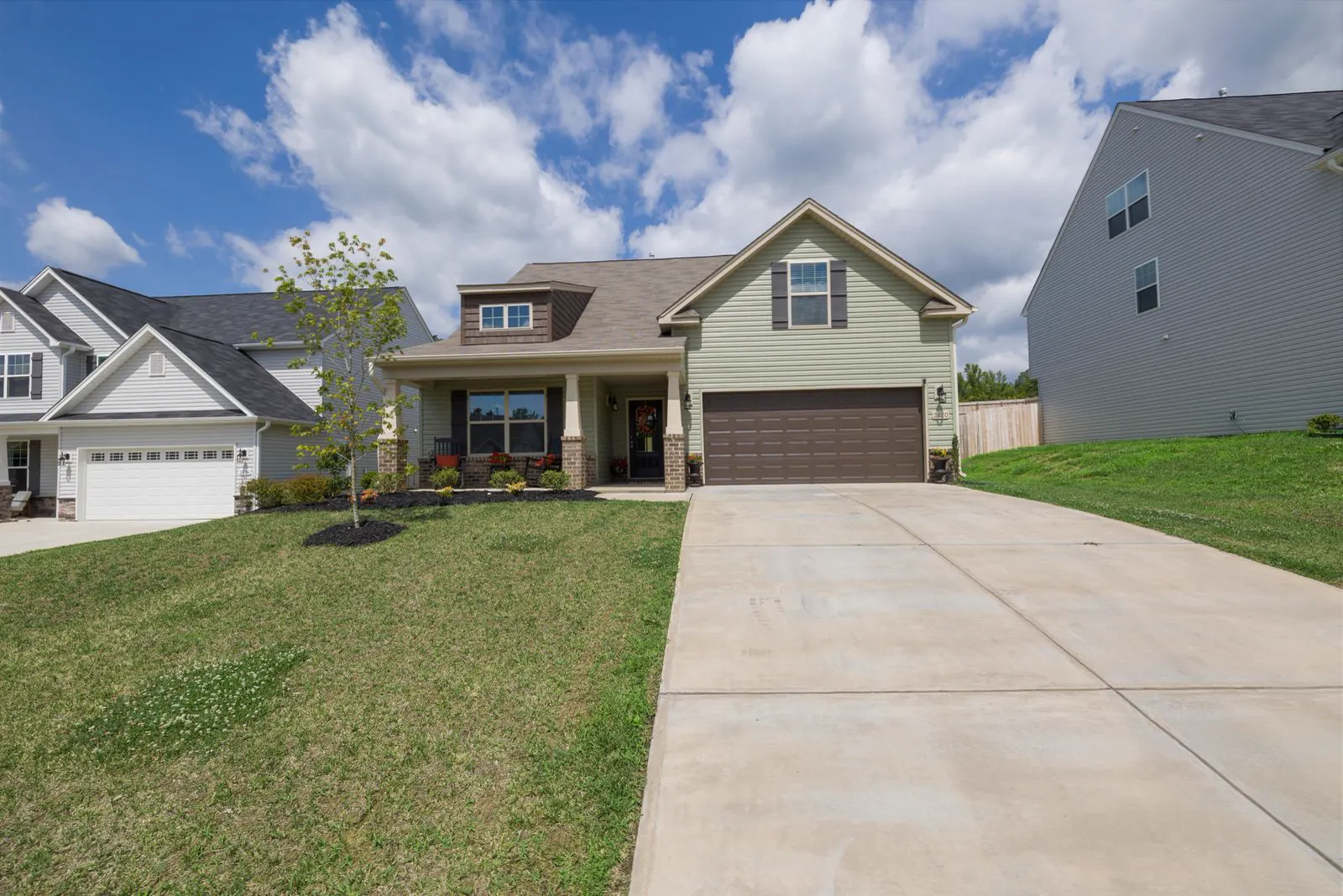 Suburban home with a wide concrete driveway and tidy lawn